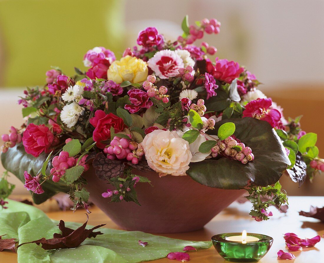 Bowl of roses, pinks and pink snowberries