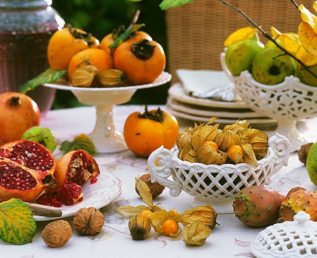 Laid table with various tropical fruits and walnuts