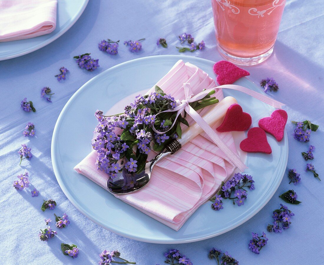 Place-setting decorated with forget-me-nots and felt hearts