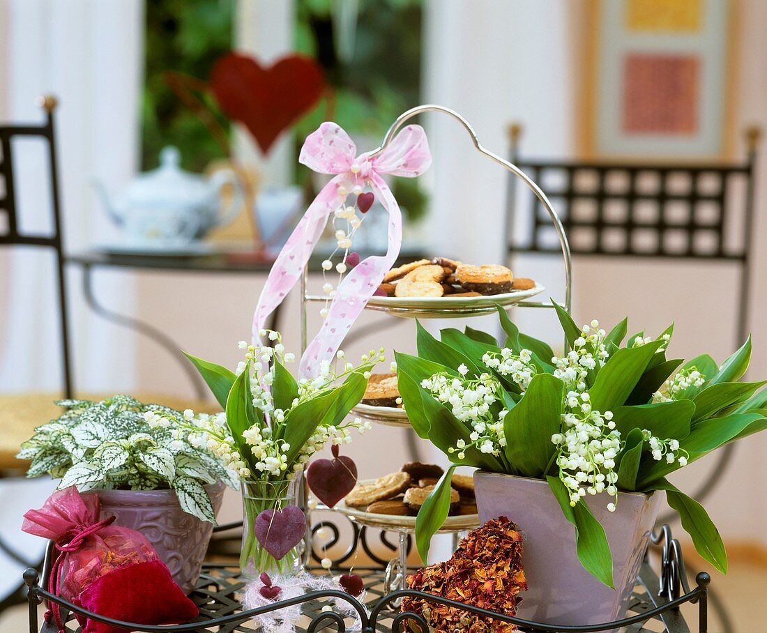 Lilies-of-the-valley & polka dot plant, biscuits on stand
