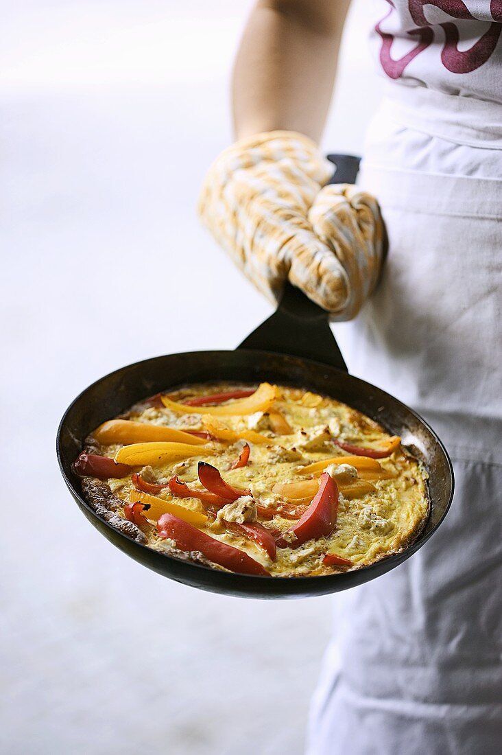 Frittata with peppers and feta in frying pan
