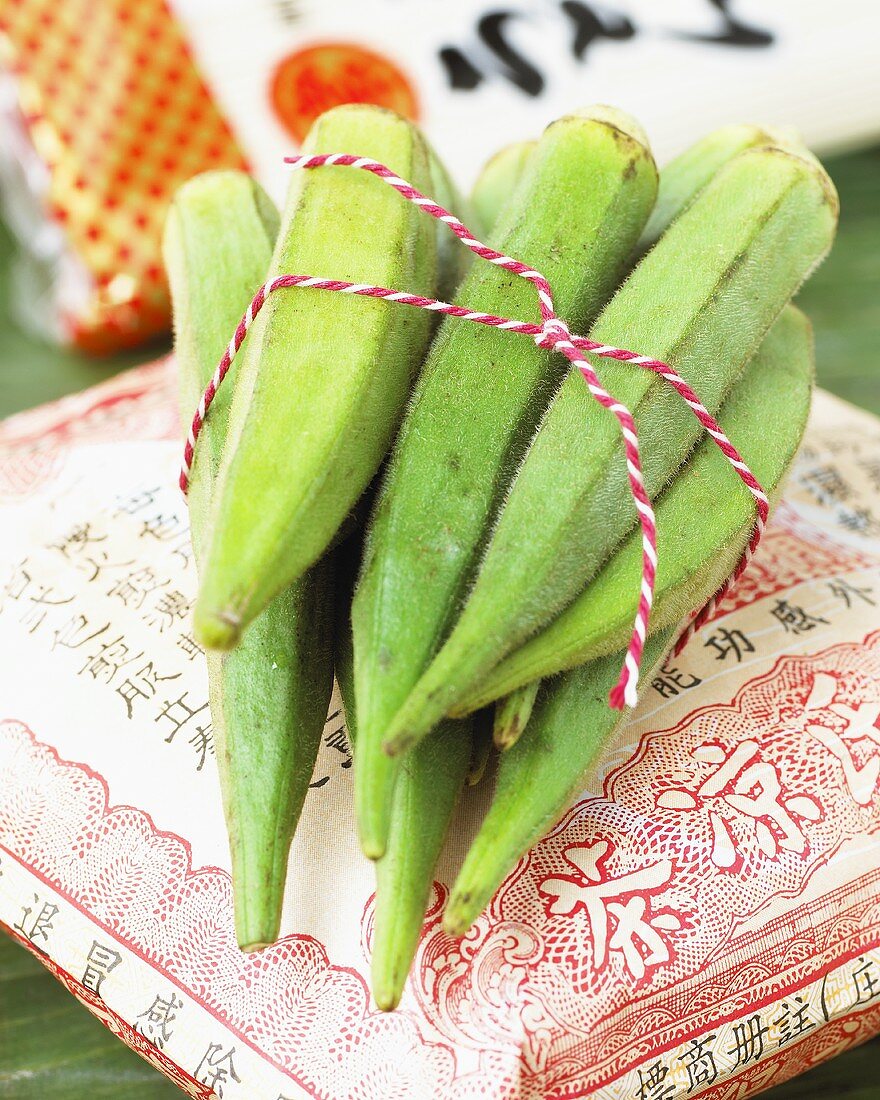 Okra pods, tied together, on Asian cushion