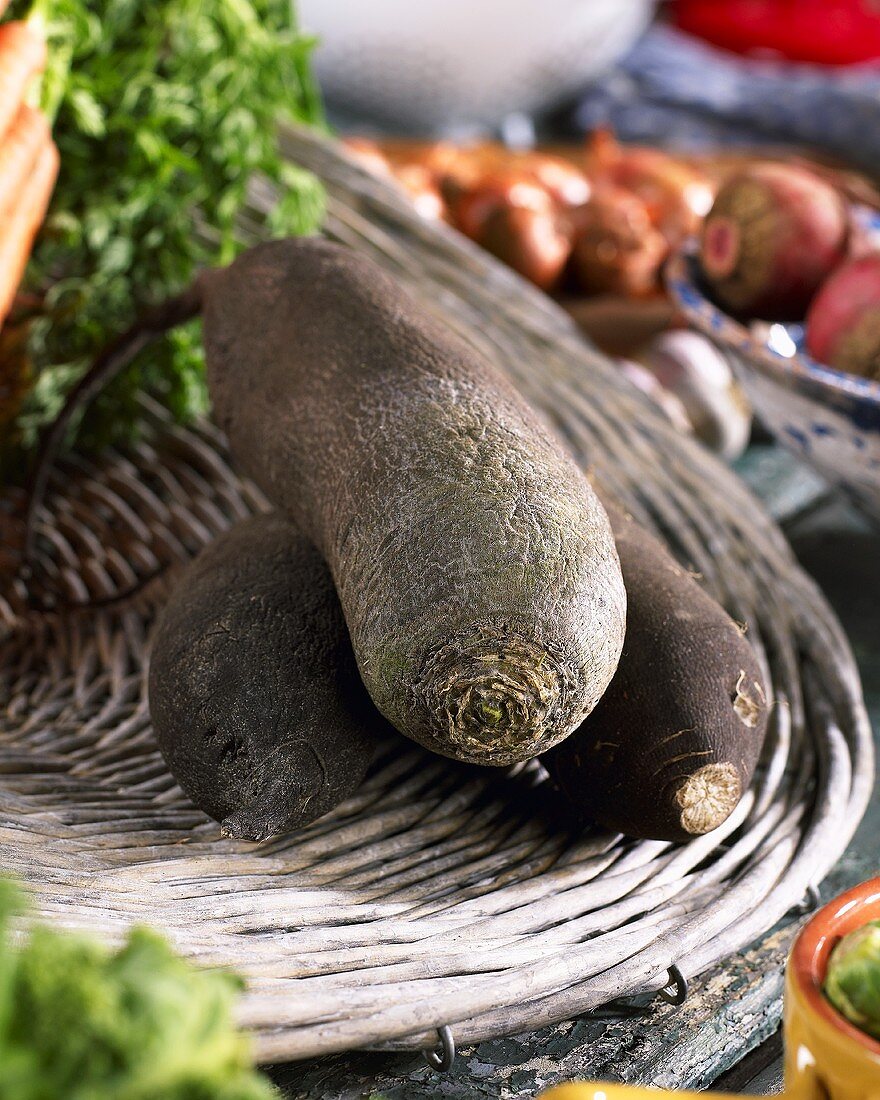 Black winter radish (Raphanus sativus ssp. niger) on wicker tray