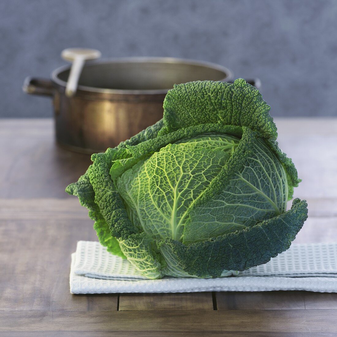 Savoy cabbage, cooking pot in background