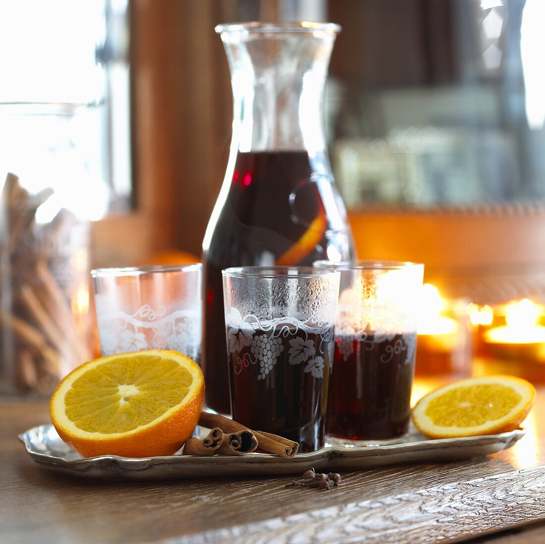 Mulled wine with oranges and cinnamon in glasses and carafe