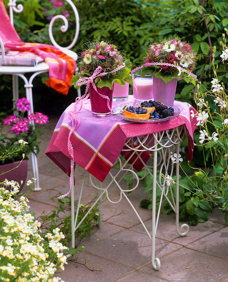 Summery table with flowers in open air