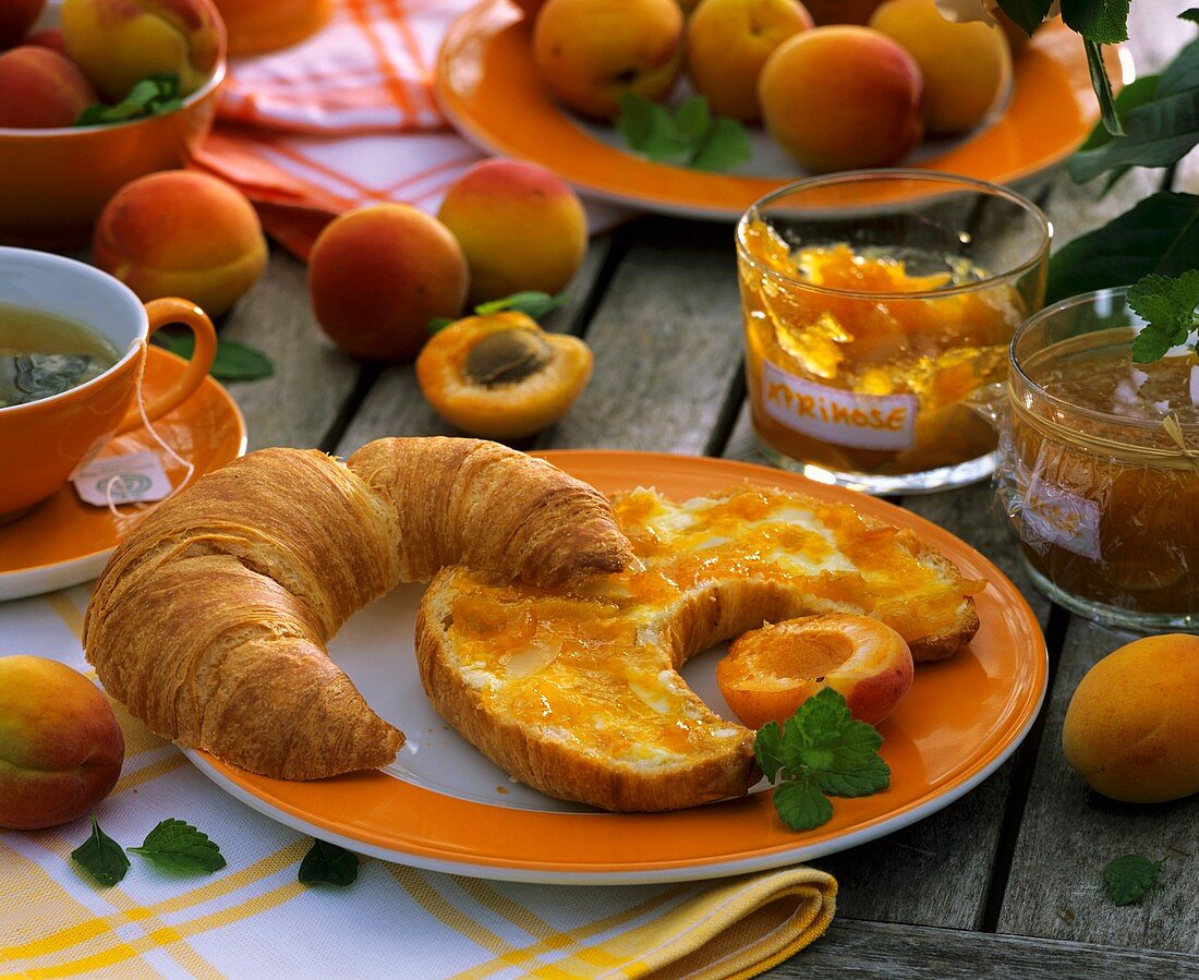 Croissant with butter and apricot jam