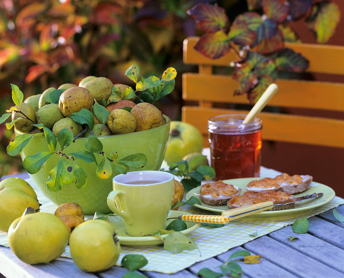 Quinces in green glass bowl and quince jelly