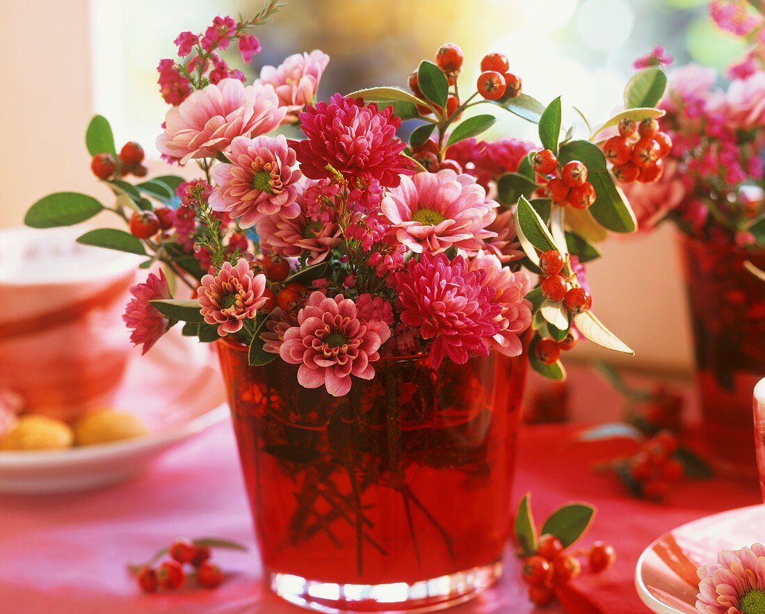 Chrysanthemums and cotoneaster in vase