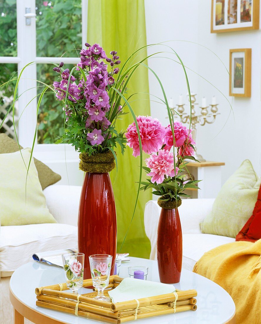 Delphiniums and peonies in vases