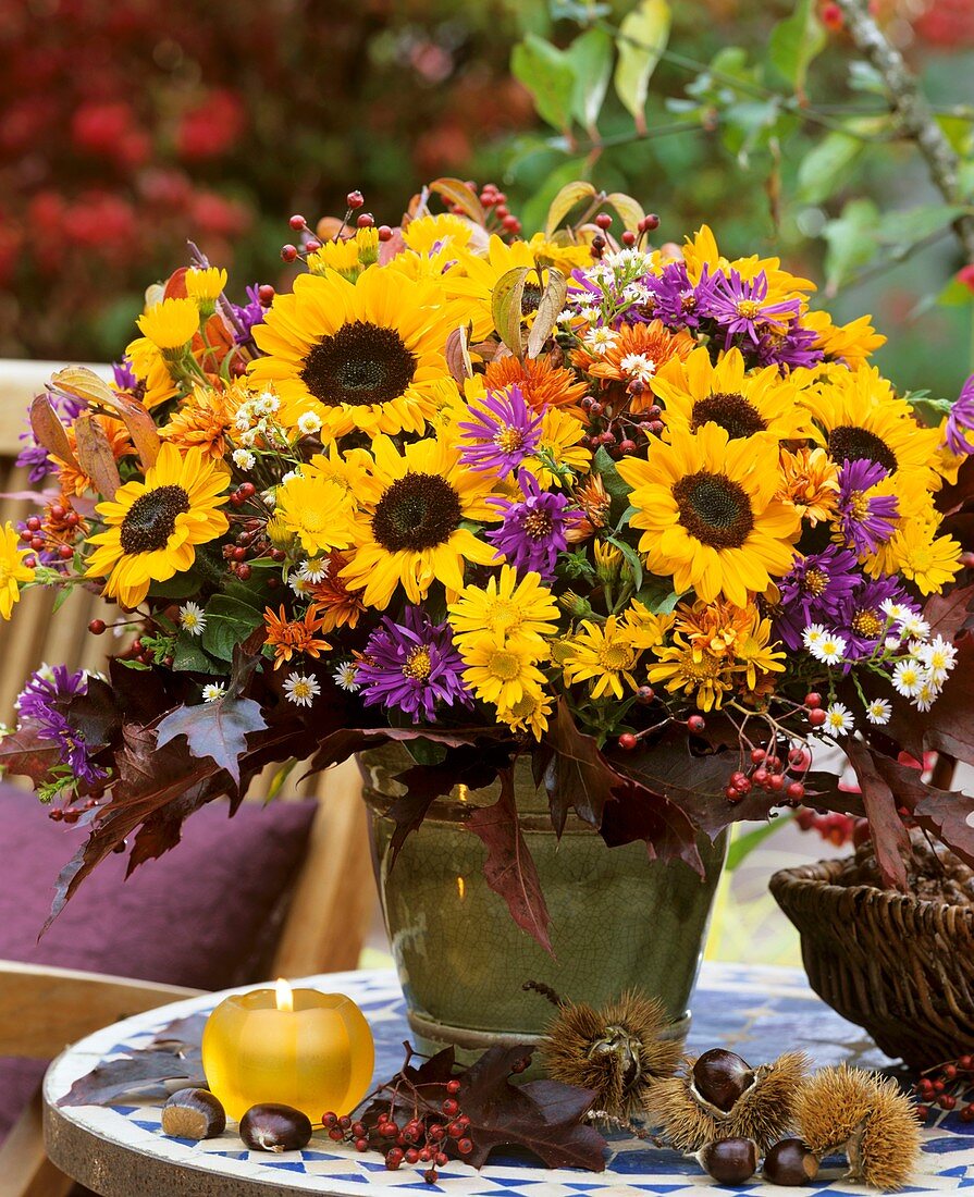 Autumn arrangement of sunflowers, Michaelmas daisies, rose hips