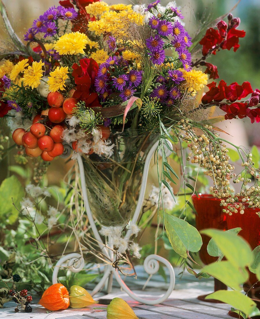 Vase of chrysanthemums, Michaelmas daisies & ornamental apples