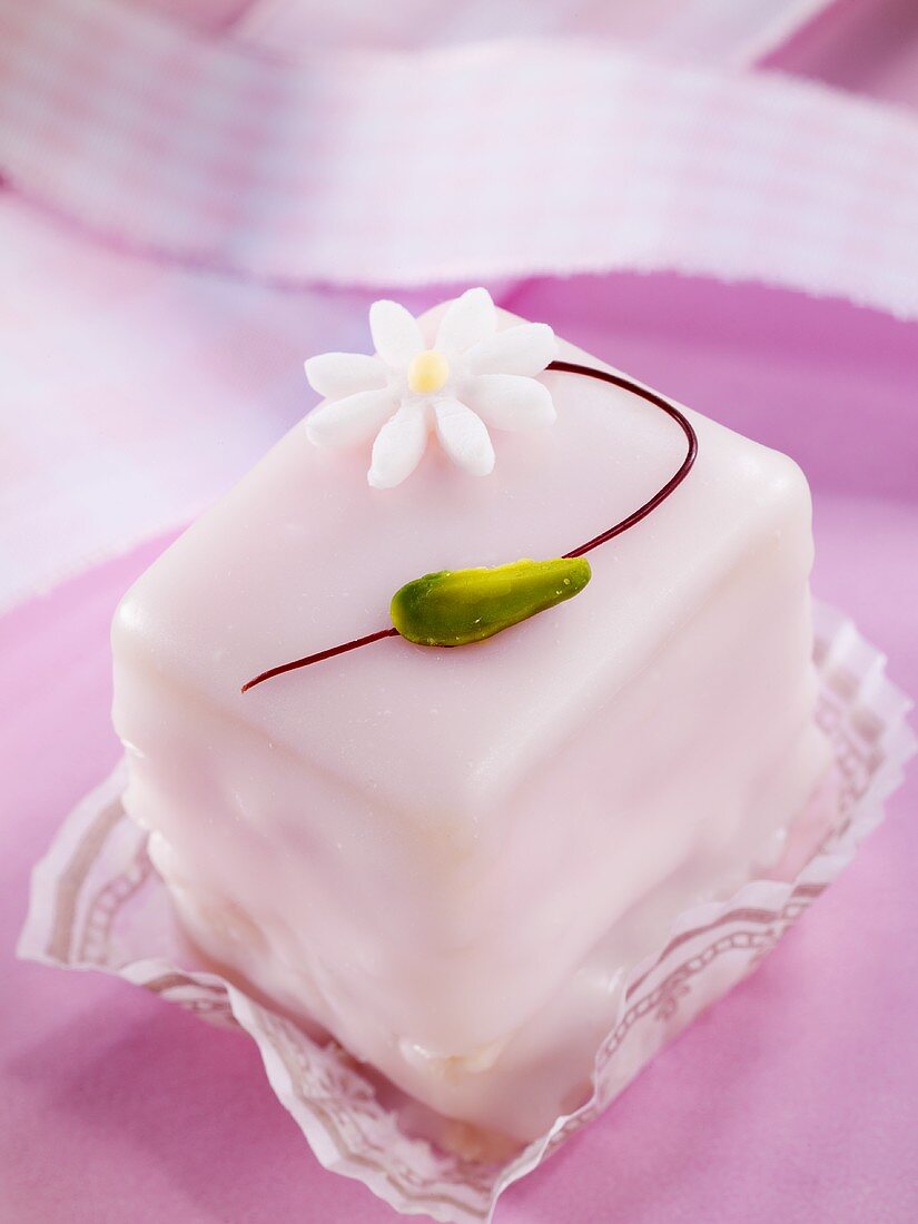 A petit four decorated with a flower