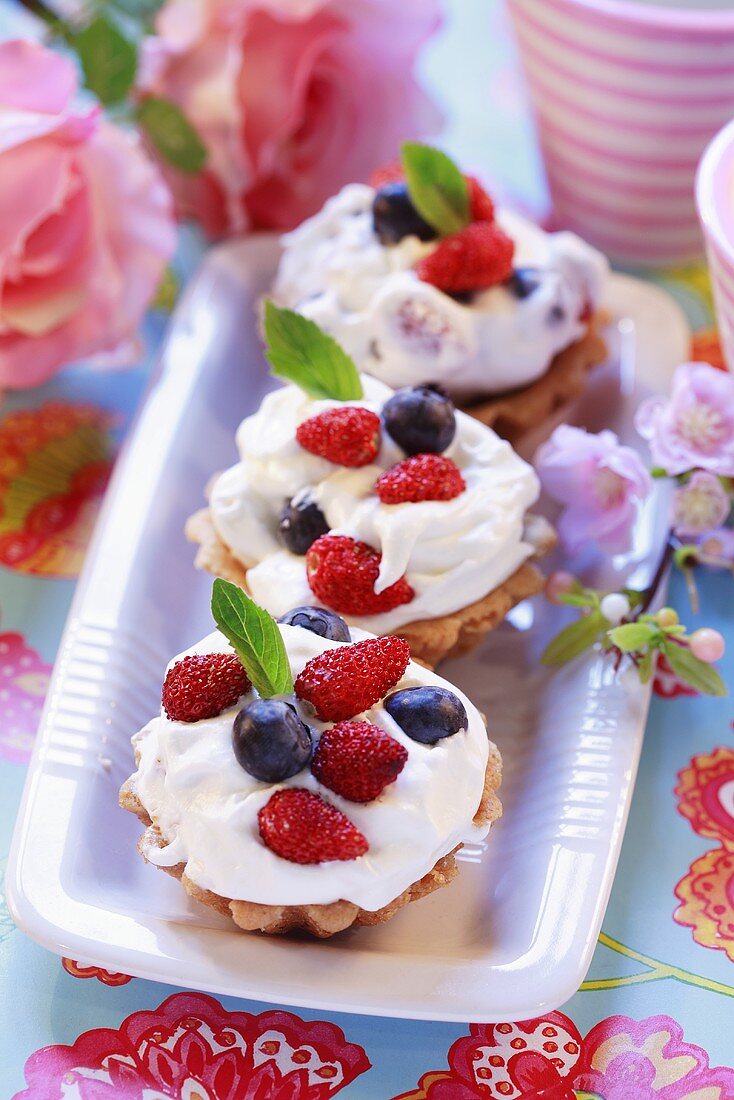 Wild strawberry and blueberry cream tarts