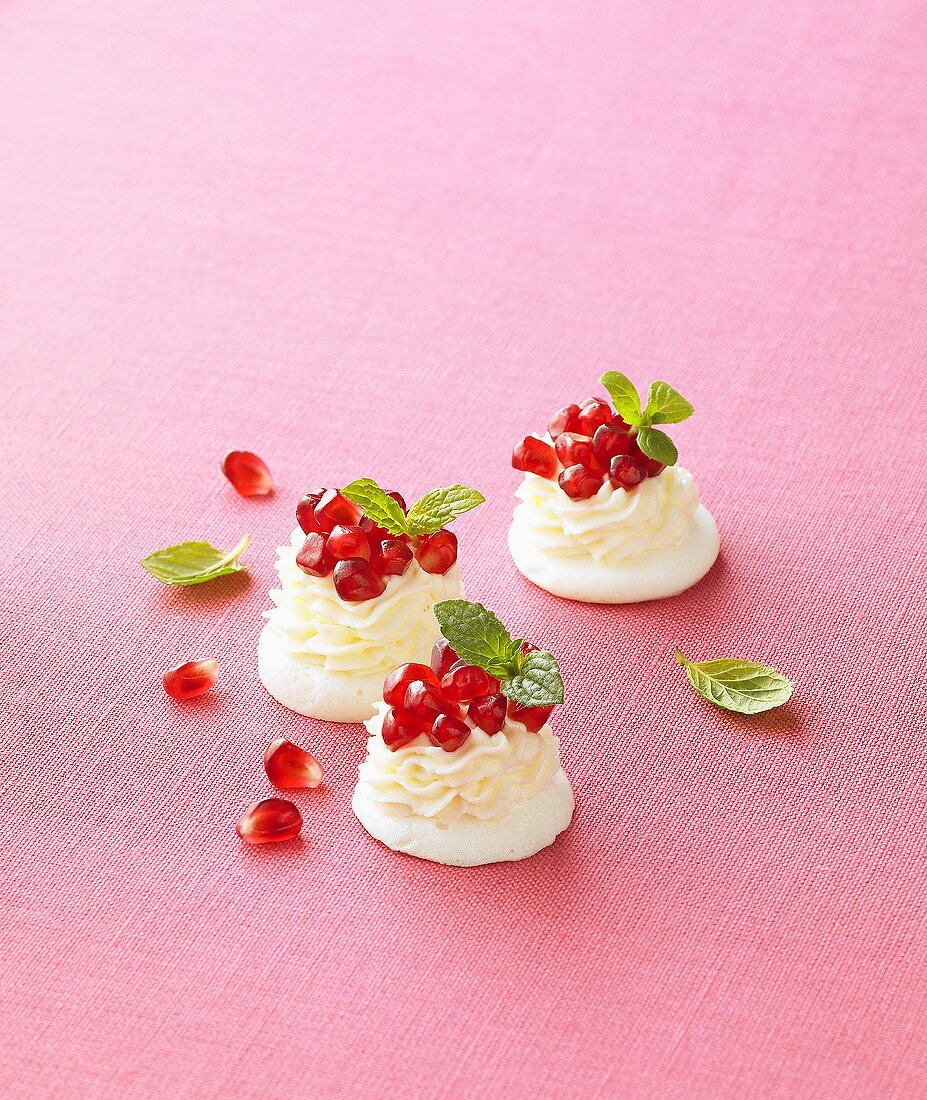 Meringues with cream and pomegranate seeds