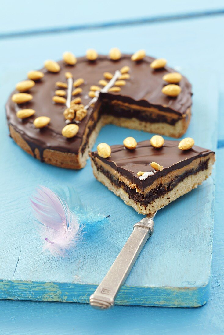 Mazurek with peanut butter and chocolate icing (a piece cut)