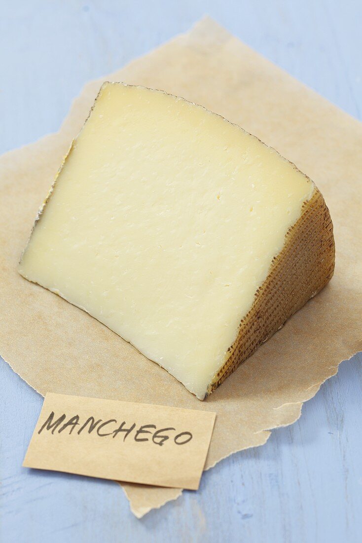 Piece of Manchego cheese on paper
