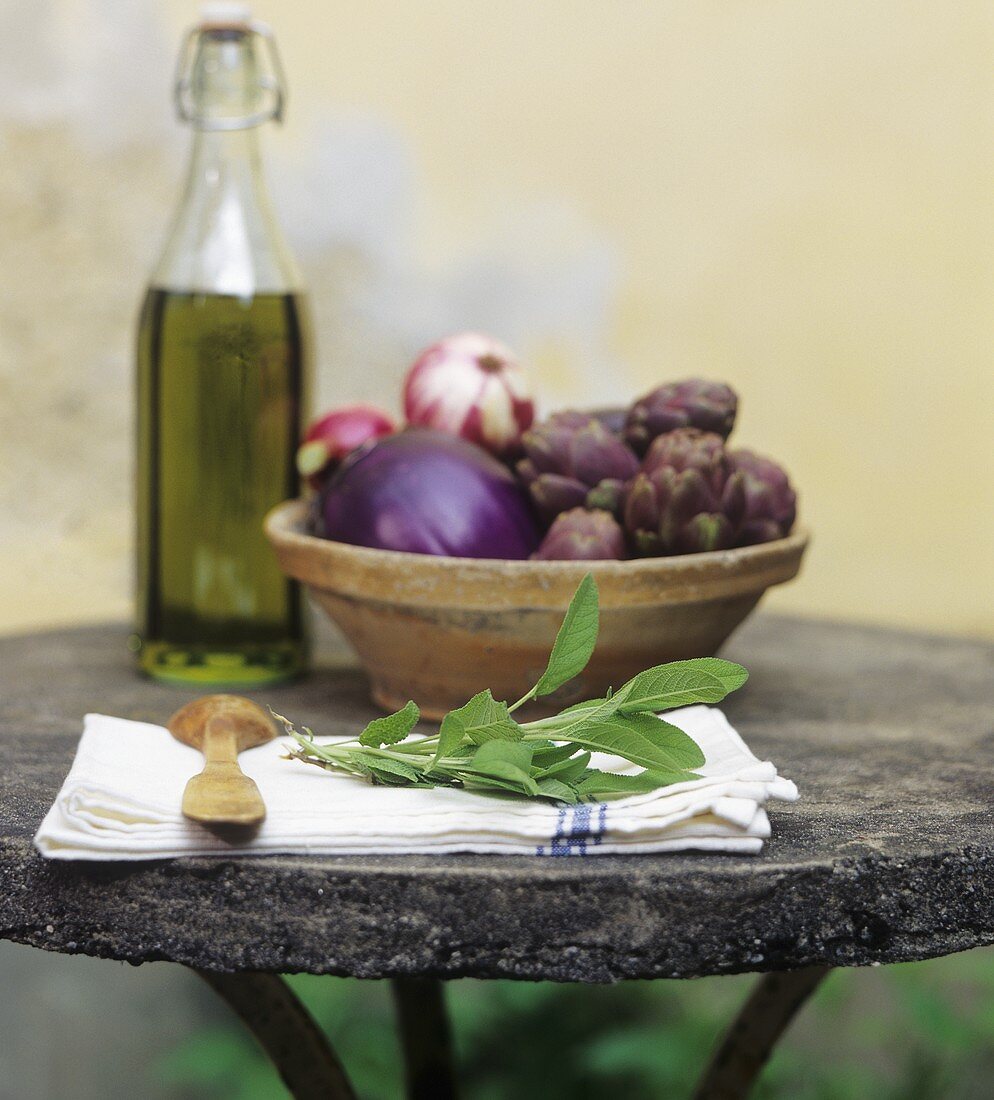 Mediterranean still life with vegetables, herbs & olive oil