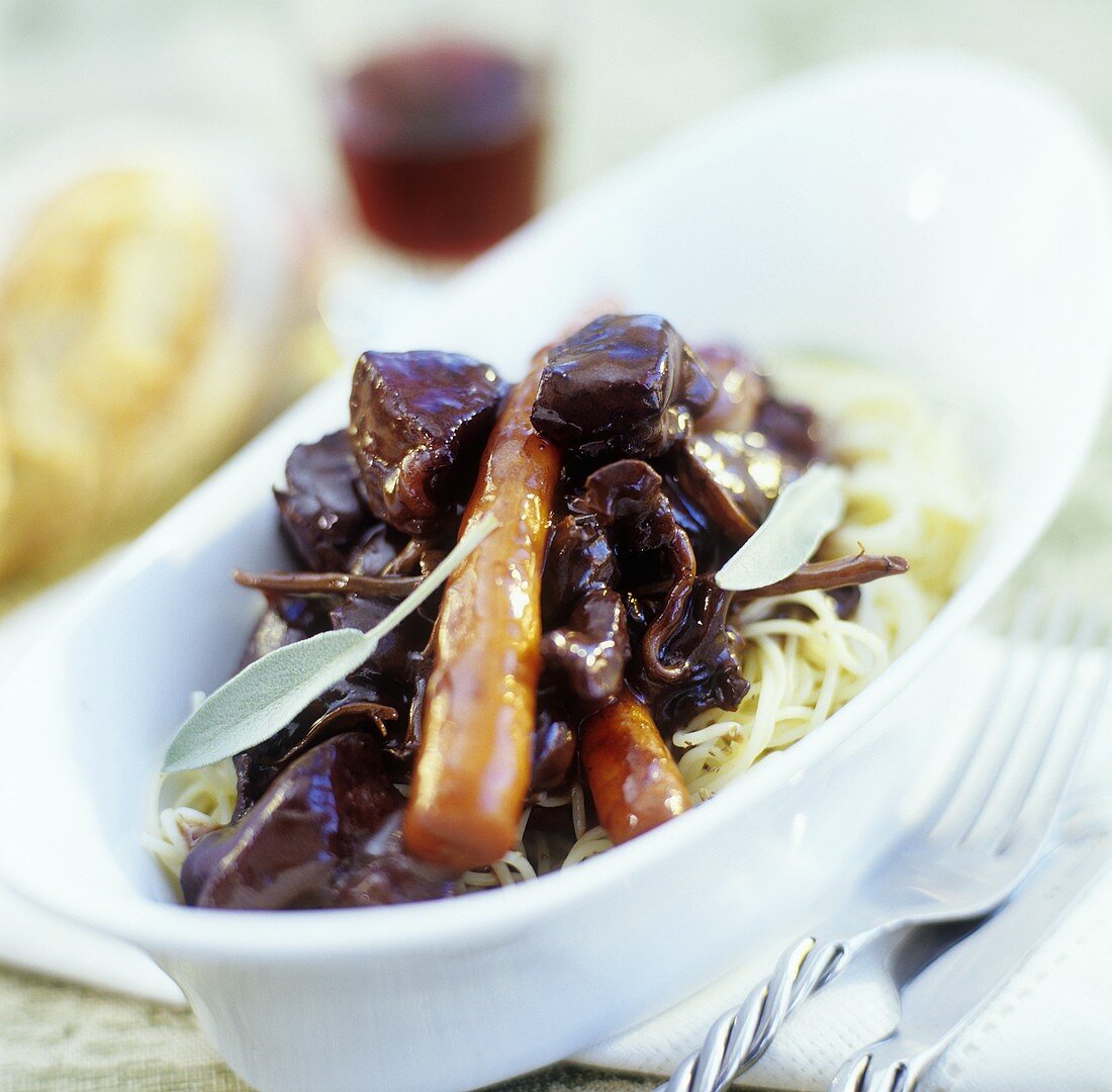 Wild boar with vegetables in red wine sauce