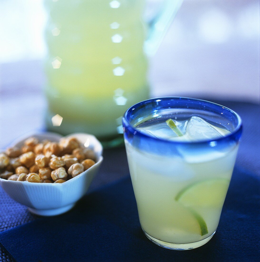 Lime drink and bowl of nibbles