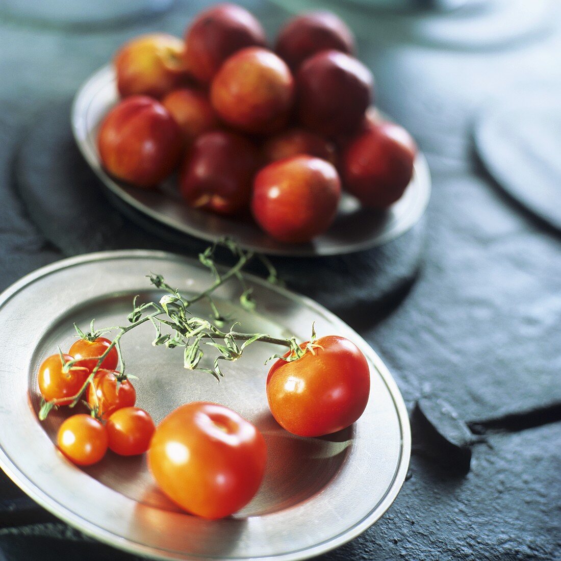 Tomatoes and plate of fruit