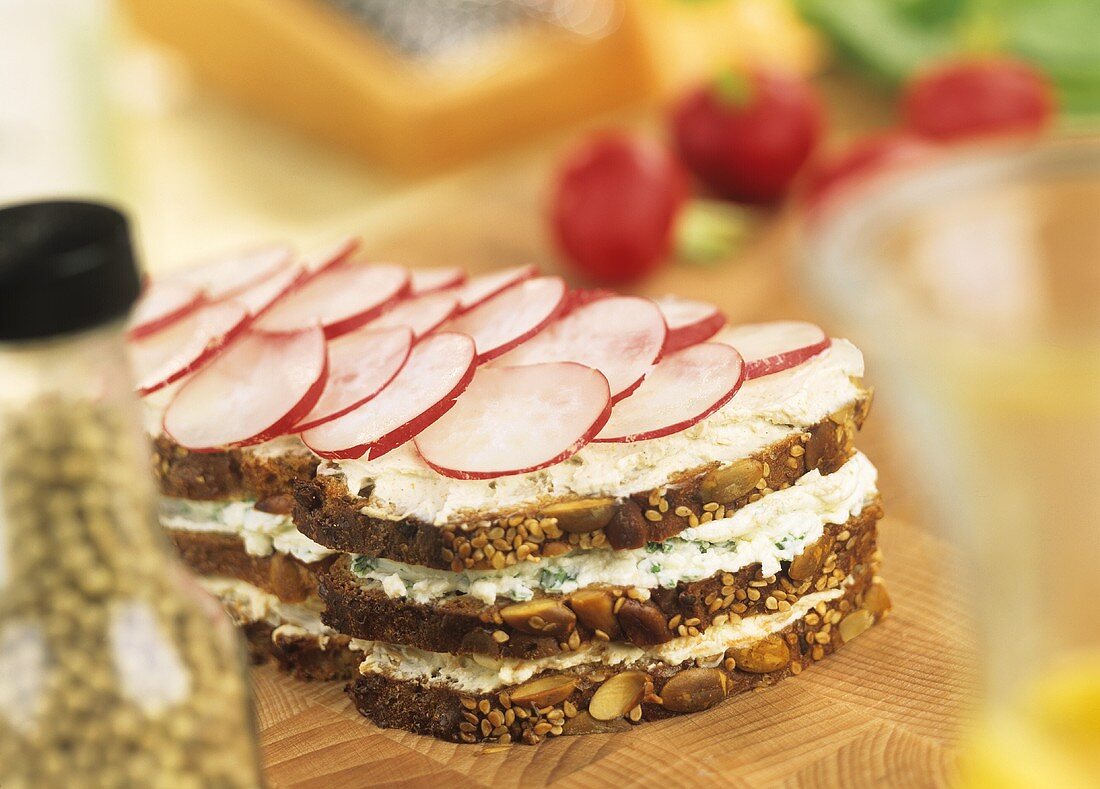 Soft cheese & radishes in wholemeal triple-decker sandwich