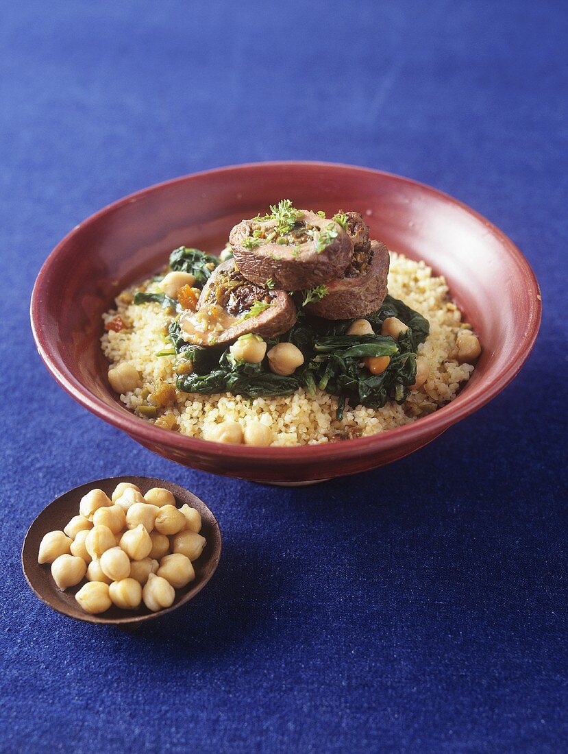 Beef roulade with spinach and chick-peas on couscous