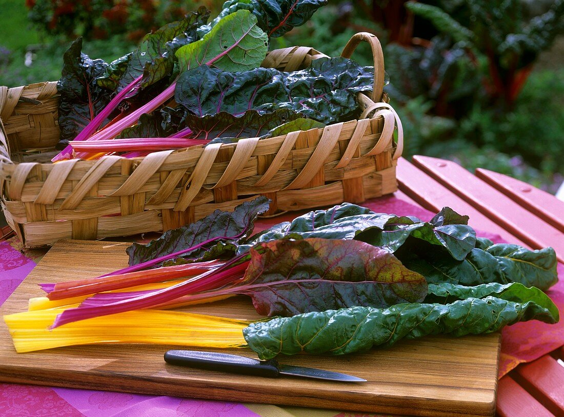 Chard with coloured stems on chopping board