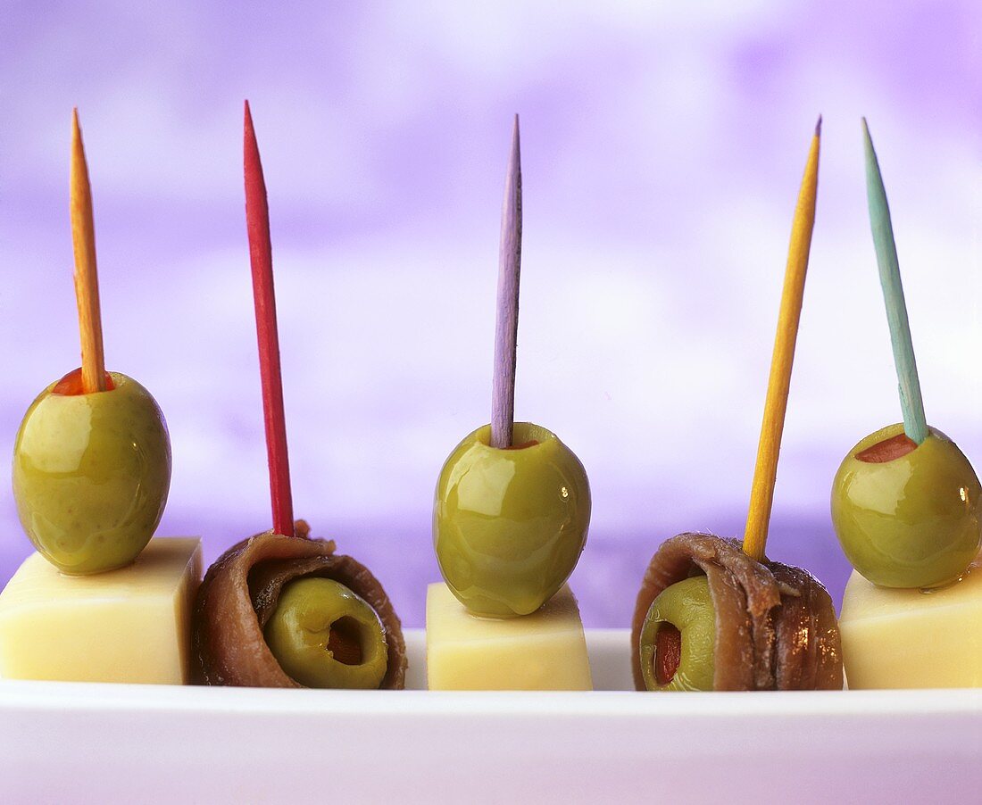 Cheese, olives and anchovies on cocktail sticks