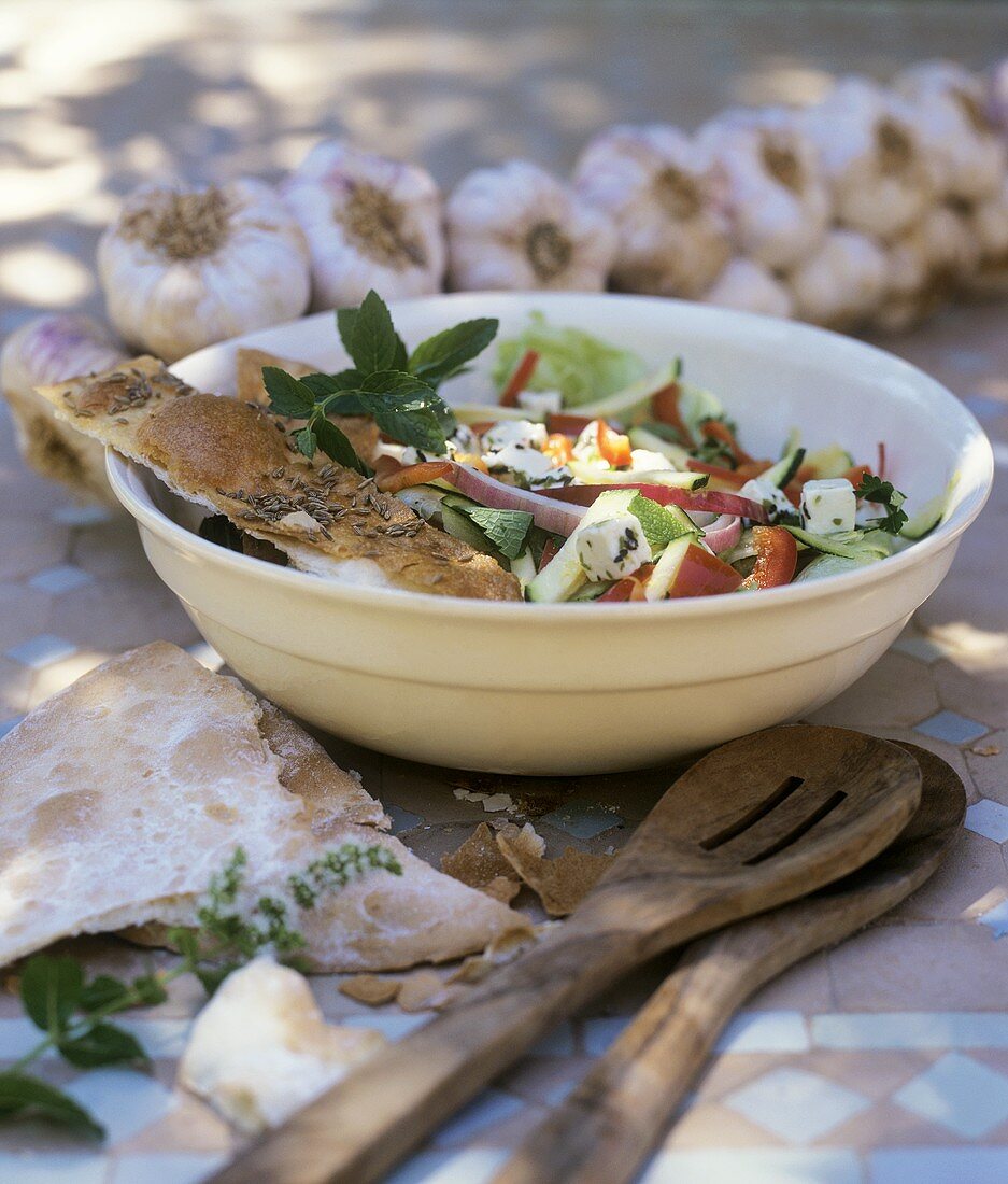 Summer salad with garlic, feta and toasted bread