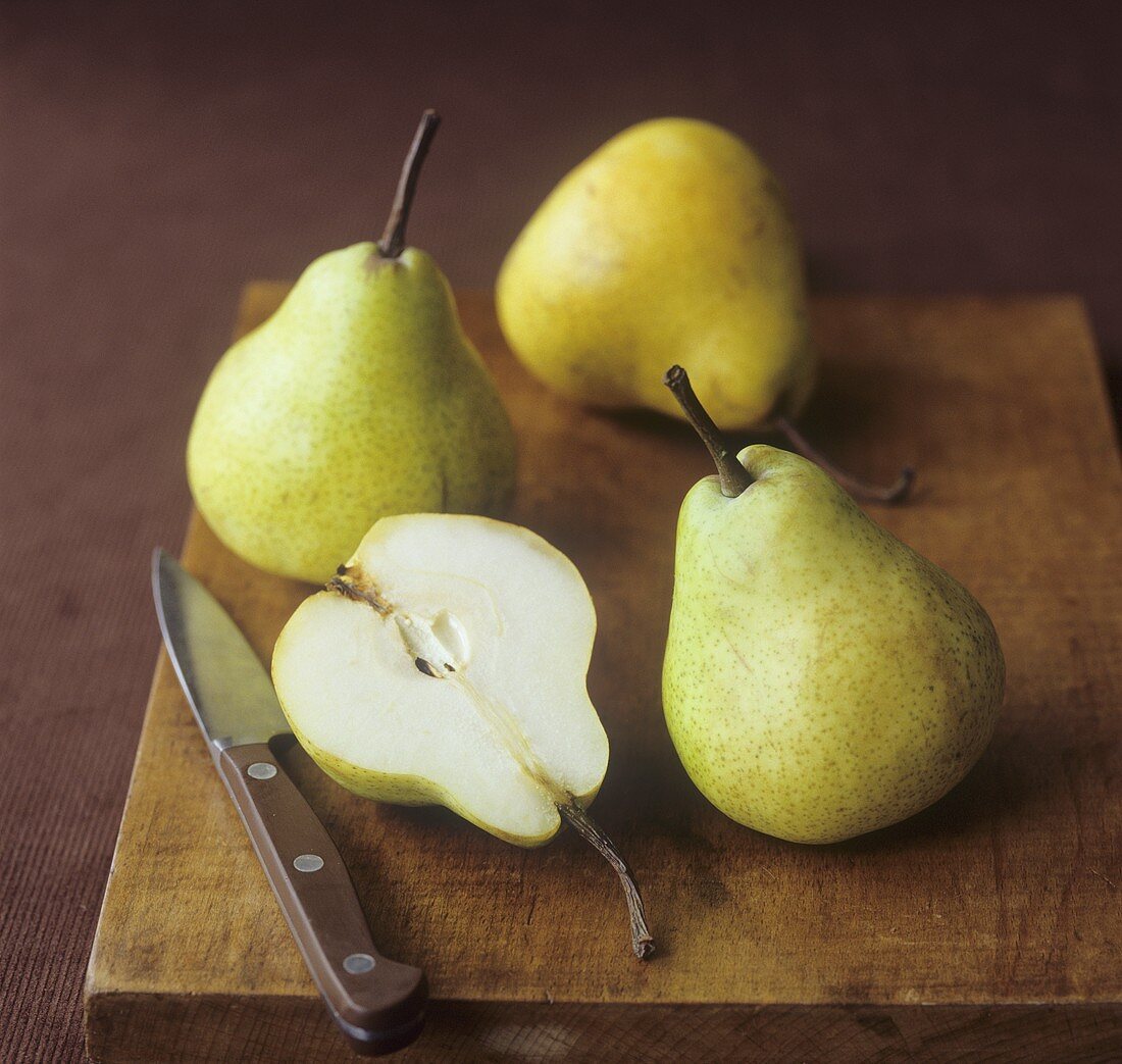 Pears with knife on a chopping board