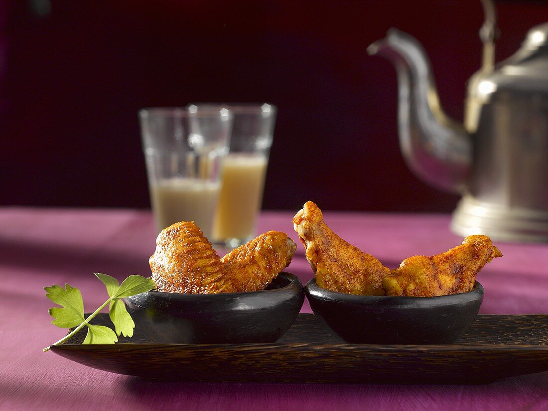 Chicken wings, chai tea and teapot in background