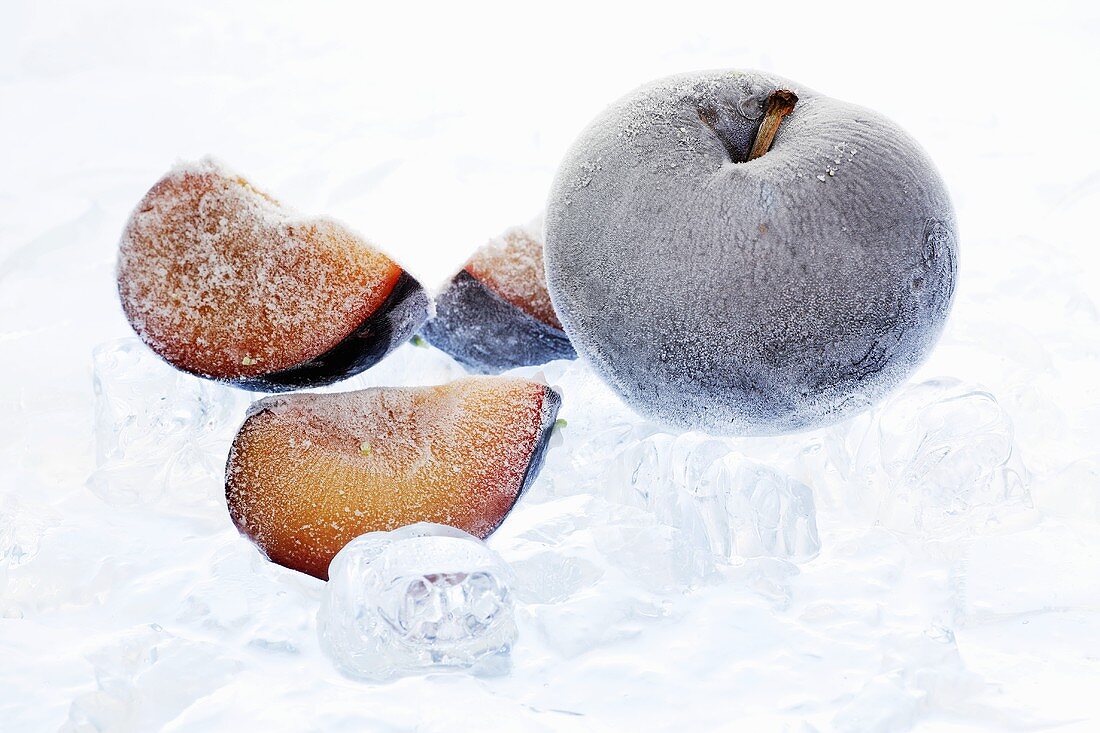 Frozen plums with ice cubes