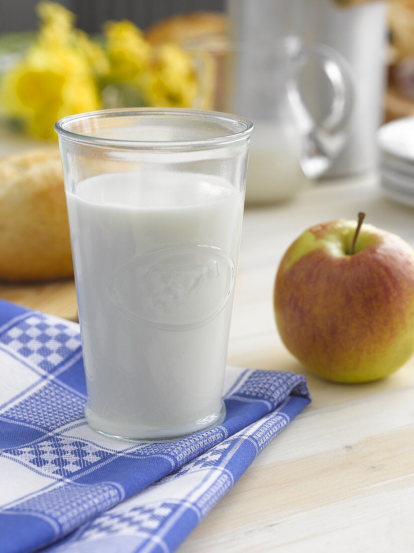 A glass of milk and an apple