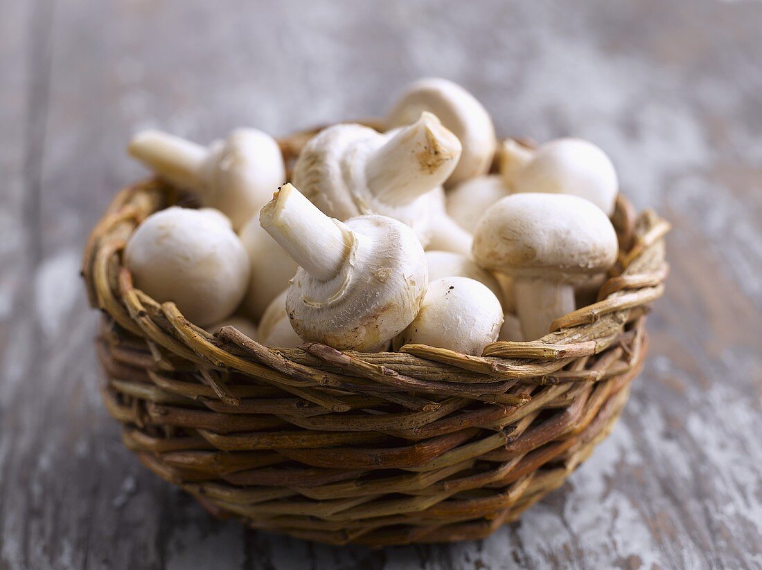 Button mushrooms in a basket