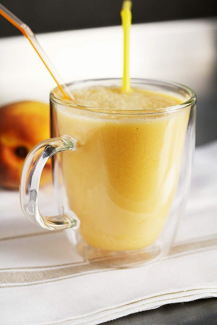 Peach smoothie in a glass cup
