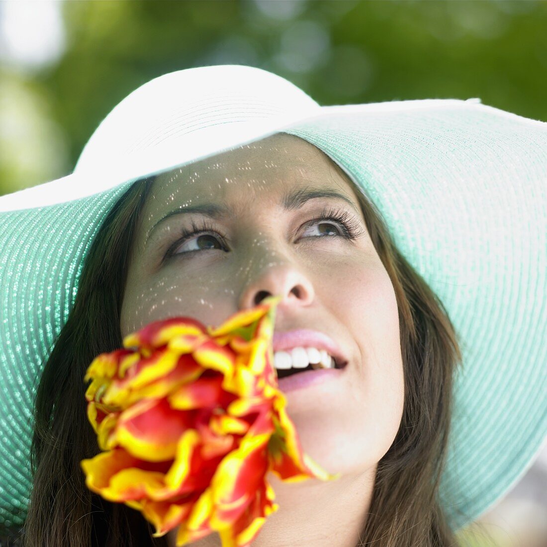 Woman in straw hat with tulip