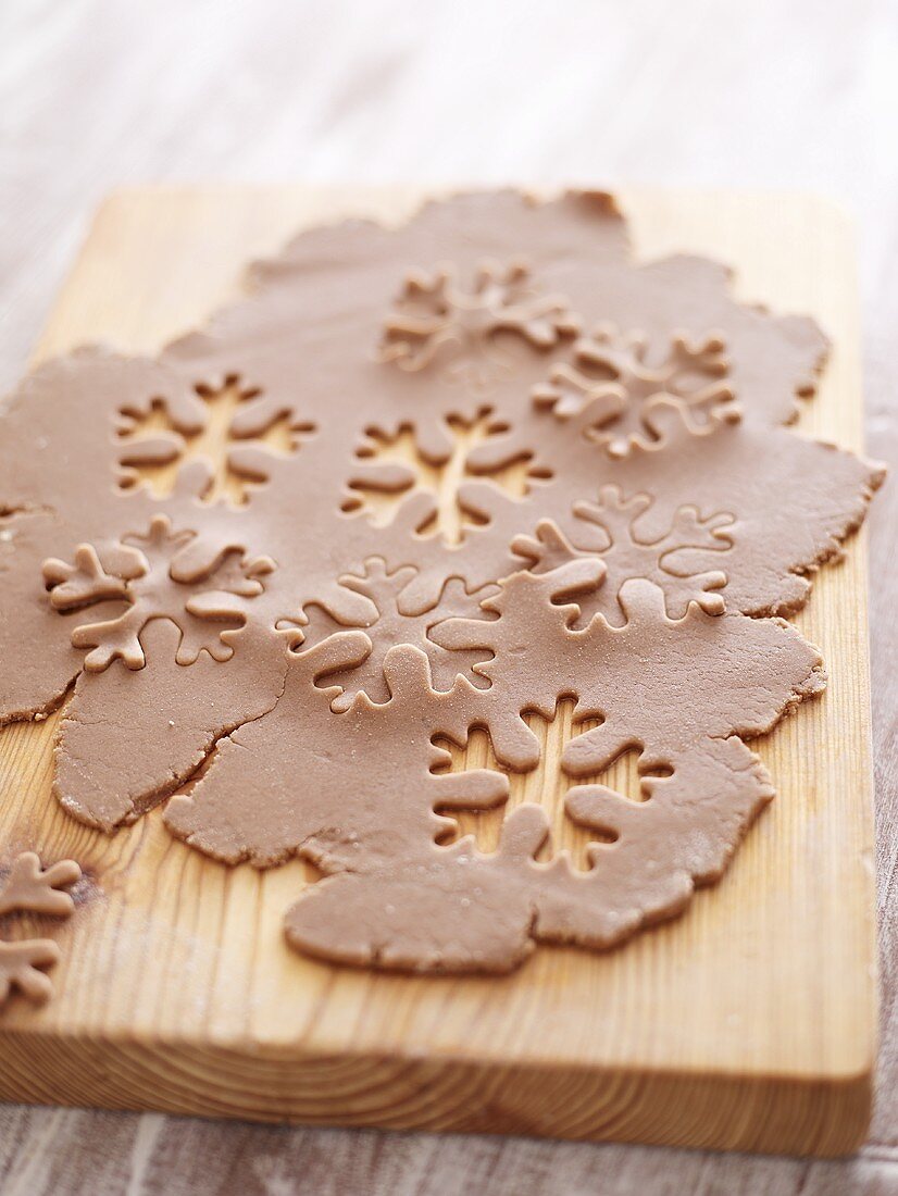 Snowflakes cut out of Lebkuchen (gingerbread) dough