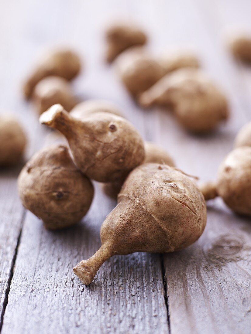 Jerusalem artichokes on wooden background