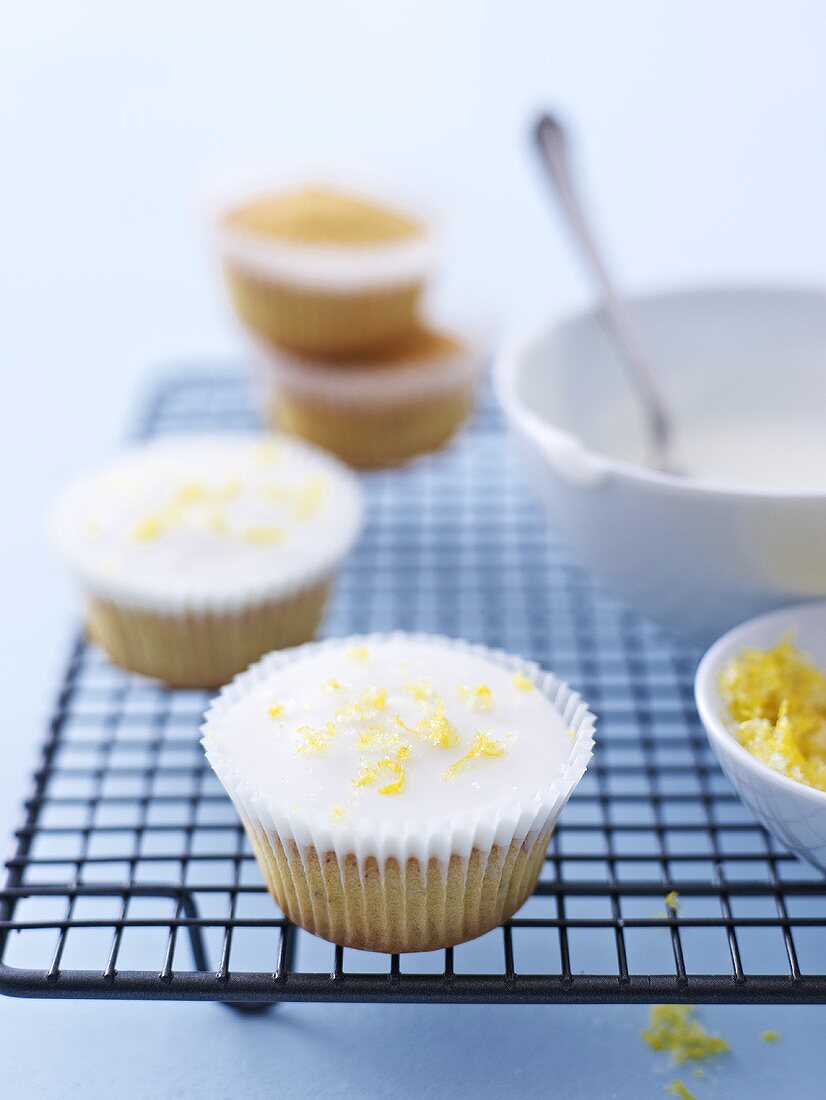 Cupcakes with lemon icing on cake rack