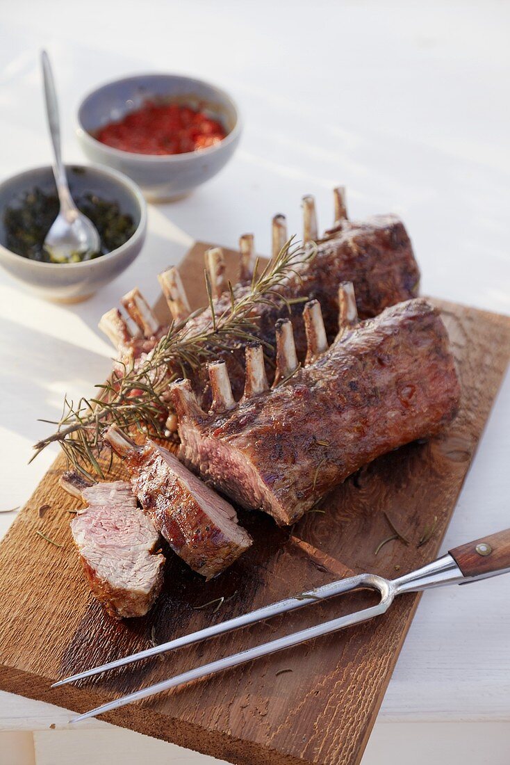 Barbecued racks of lamb with rosemary, salsa rossa and salsa verde