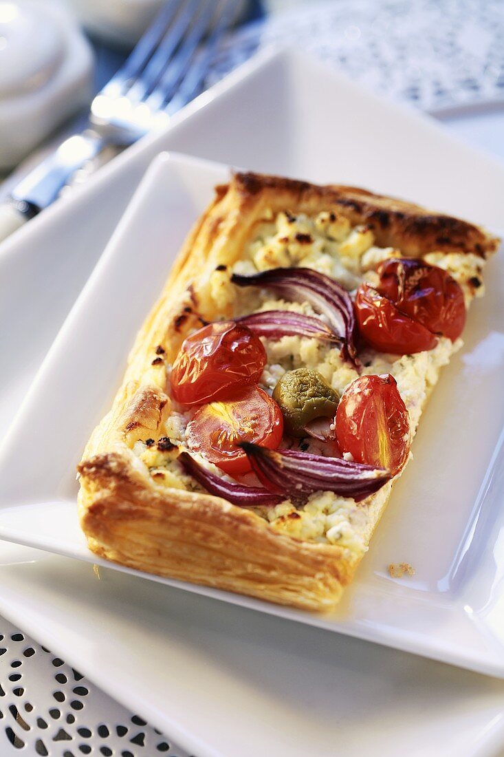 Soft cheese and tomatoes in puff pastry case