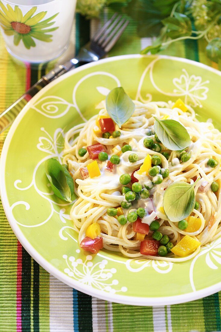 Spaghetti mit Gemüse und Basilikumblättern