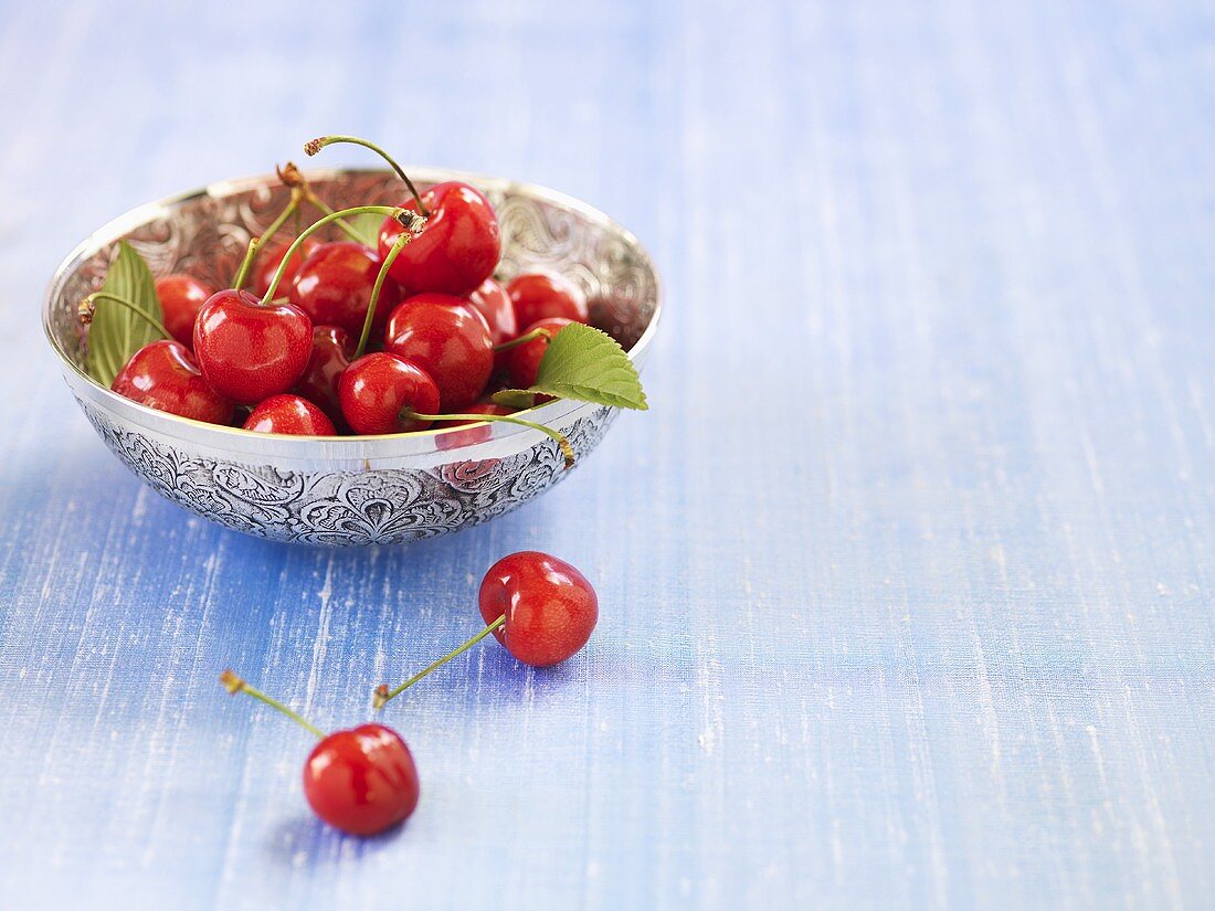 Fresh cherries in a silver dish