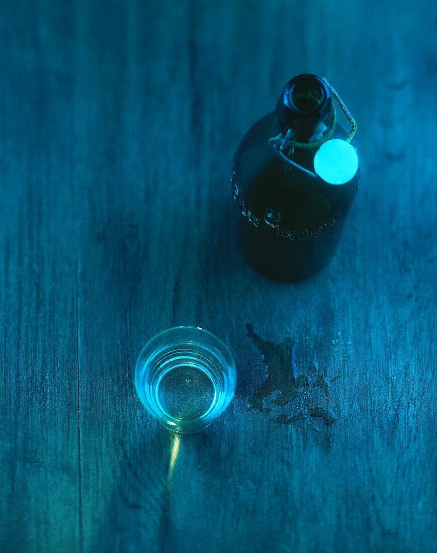 Old flip-top bottle and a glass of water