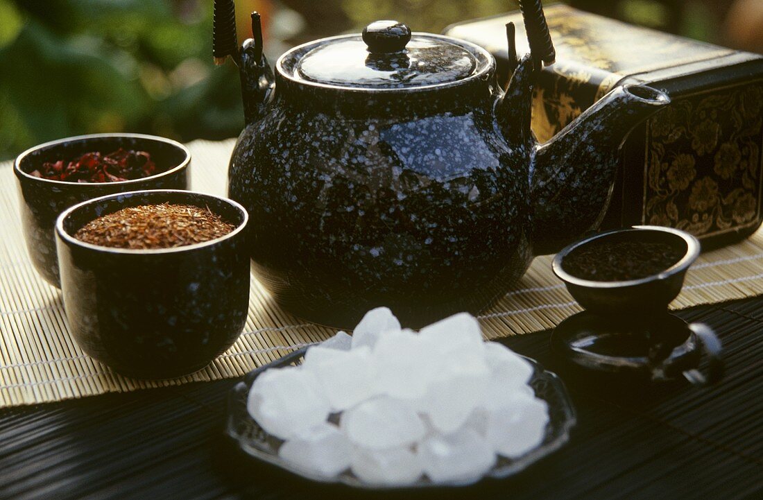 Sugar crystals, various types of tea and teapot
