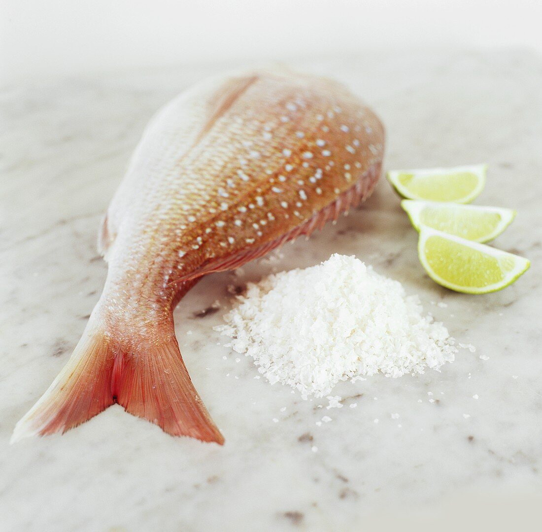 Red snapper with sea salt and lime wedges