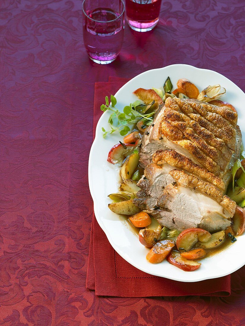 Roast pork with crackling with apples and vegetables