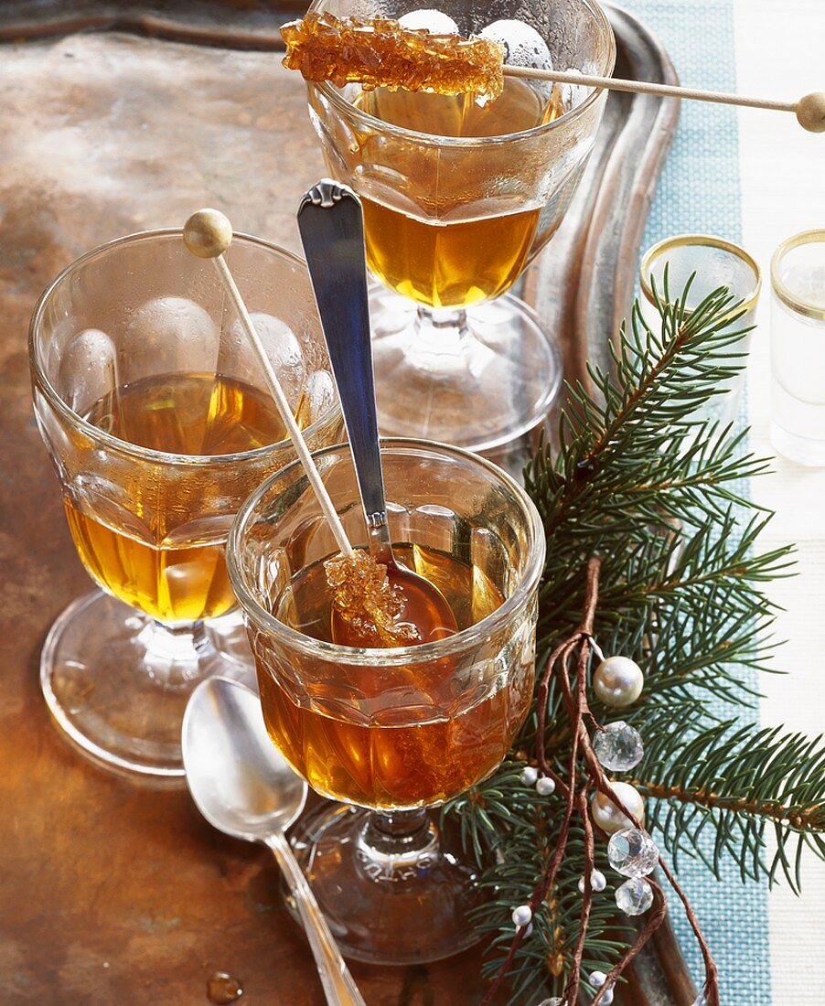 Jagertee (tea with rum) with sugar swizzle sticks