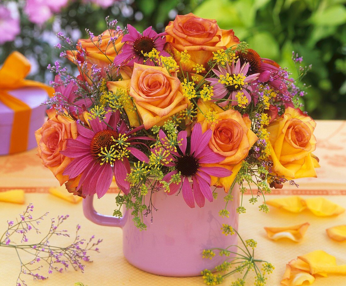 Arrangement of roses, fennel & purple coneflower in small jug